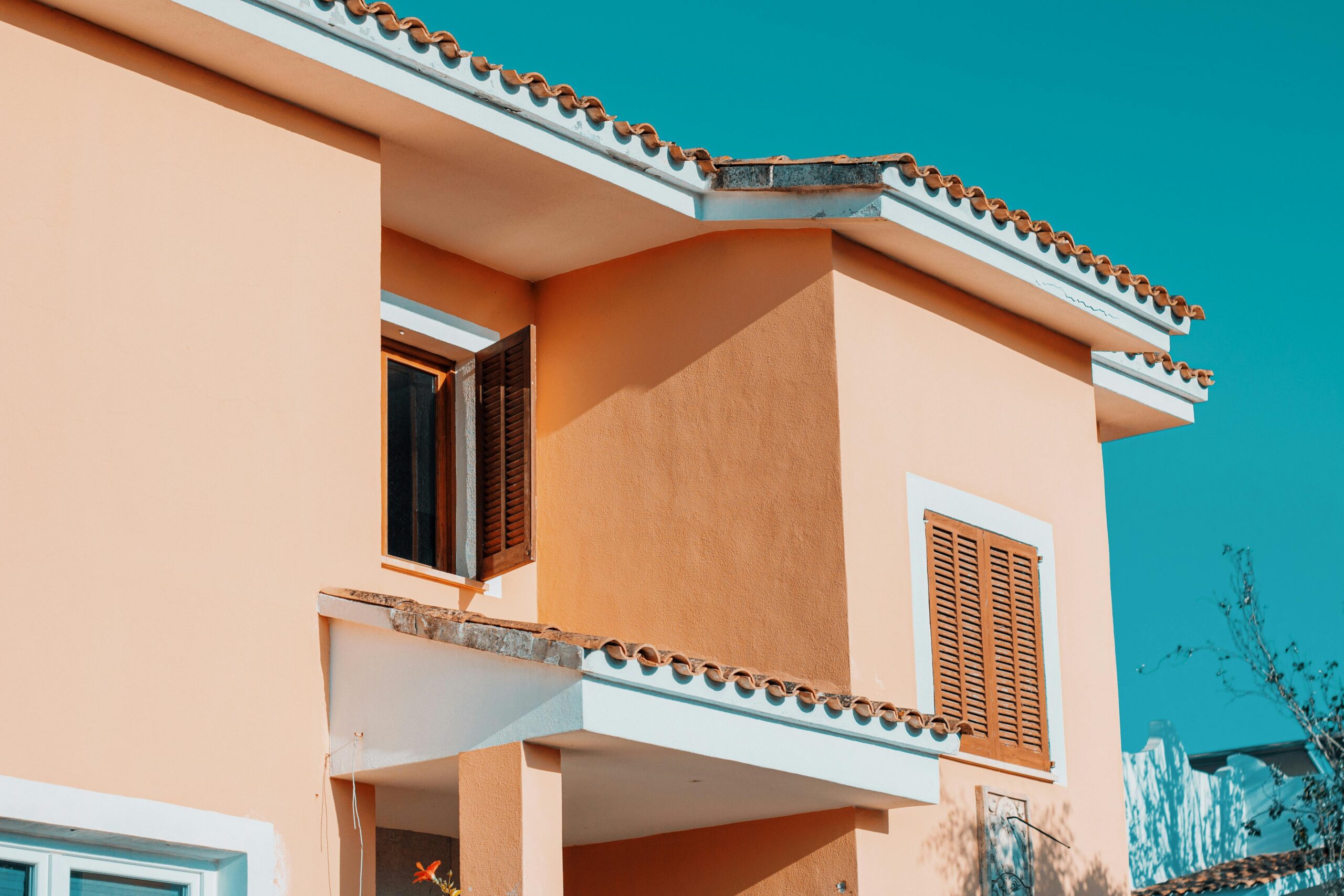 Exterior façade painting in beige and terracotta tones