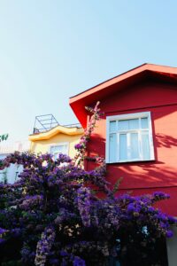 Exterior house painting in two tones, bright red and yellow
