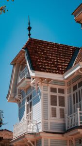 Exterior cottage façade painted in light blue with painted trim
