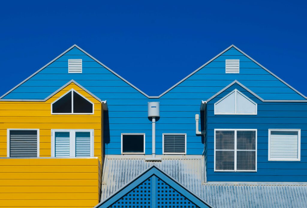 Exterior house painting in two tones, blue and yellow