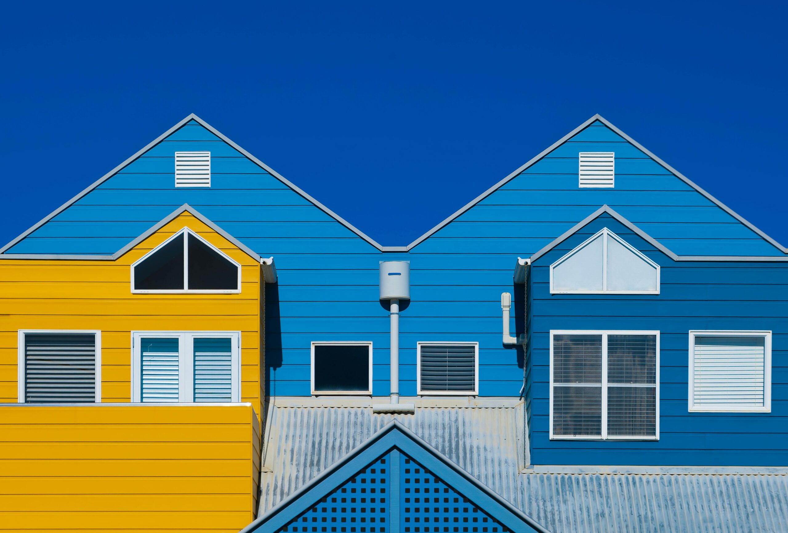 Exterior house painting in two tones, blue and yellow