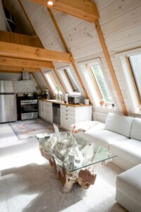 Painted wooden ceiling and beams in an attic kitchen